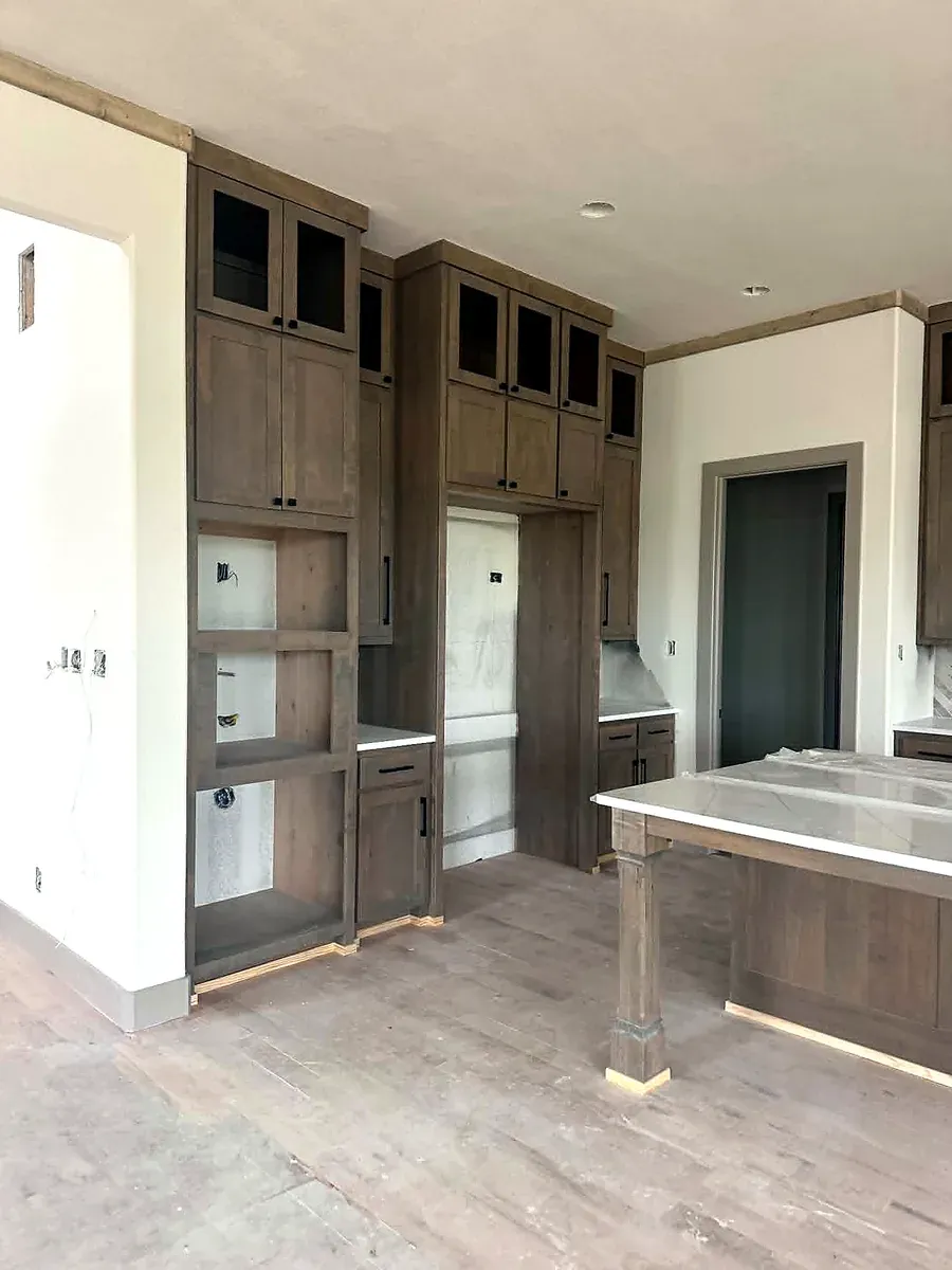 Custom built in cabinetry being installed by the Teddy team, with trim and shelving going in