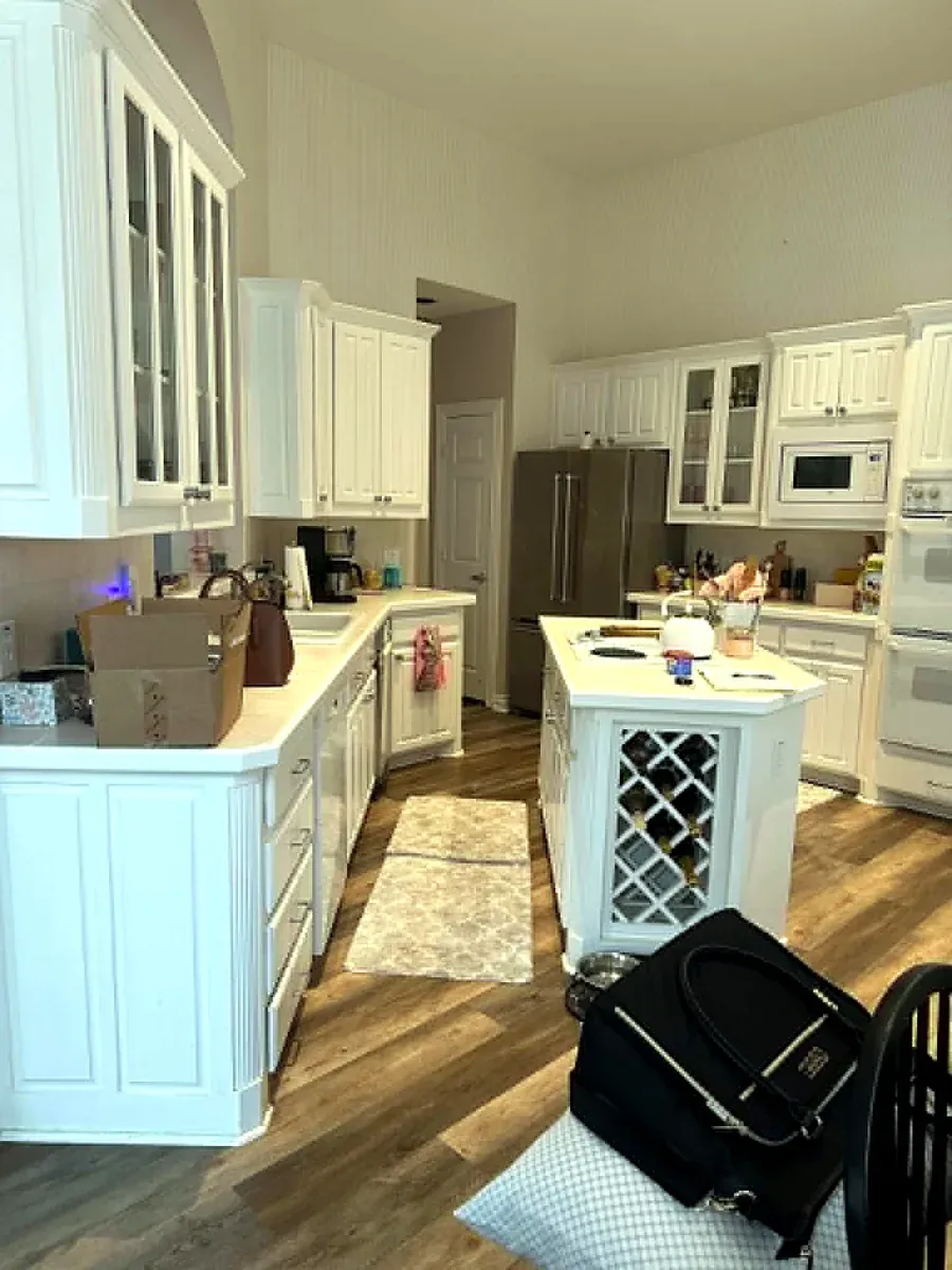 Kitchen with white cabinetry, granite counters and stainless appliances